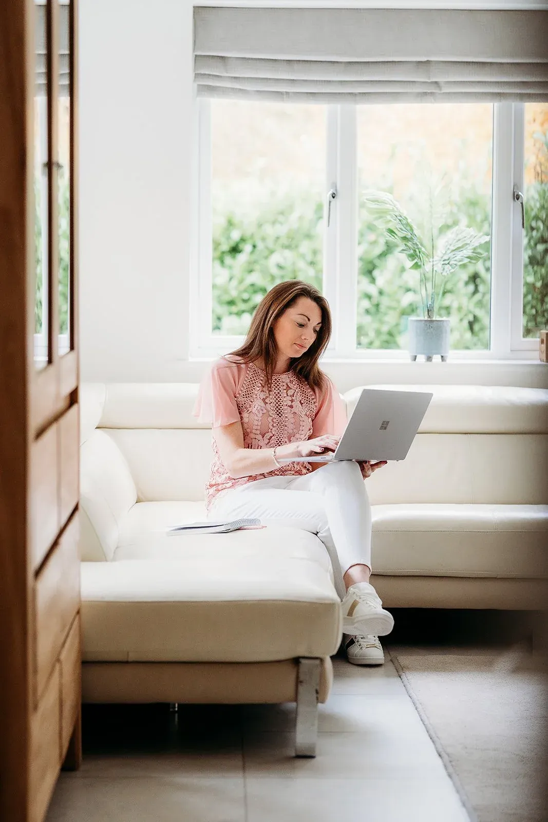 Jess Quinlan working on a laptop at home